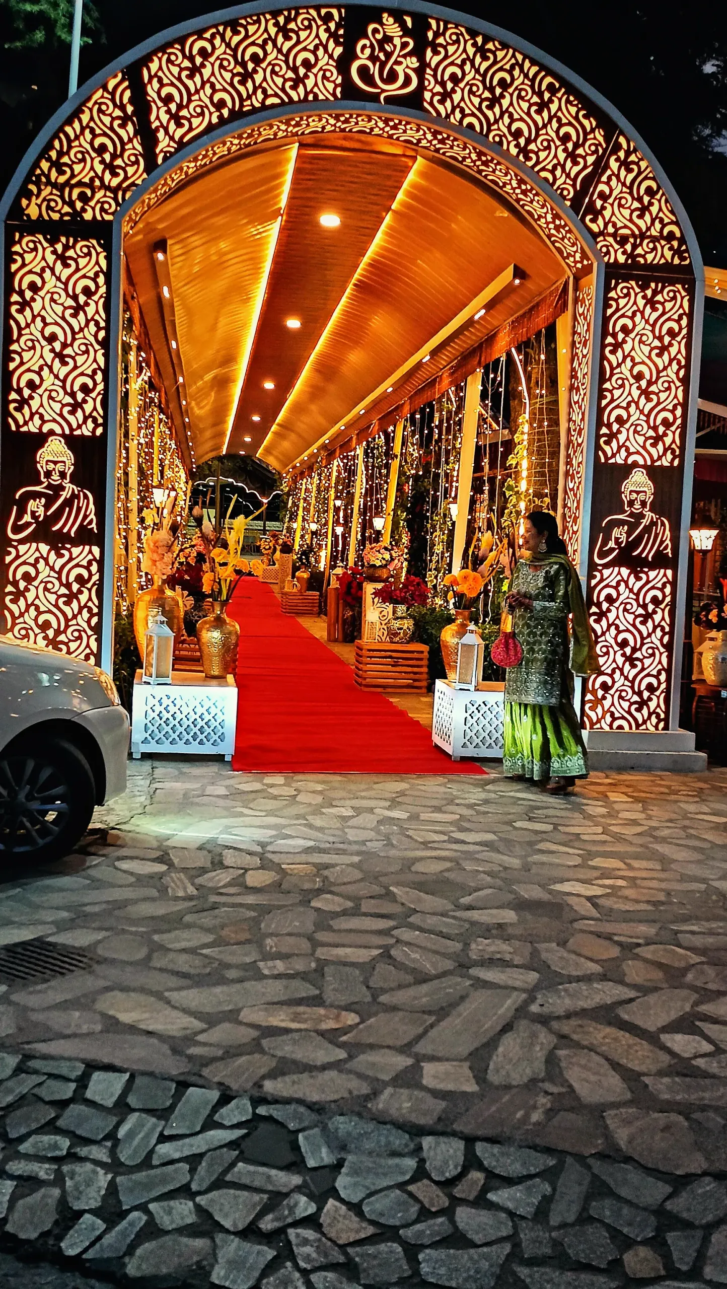 Guests arriving through the lit entrance arch on the red carpet