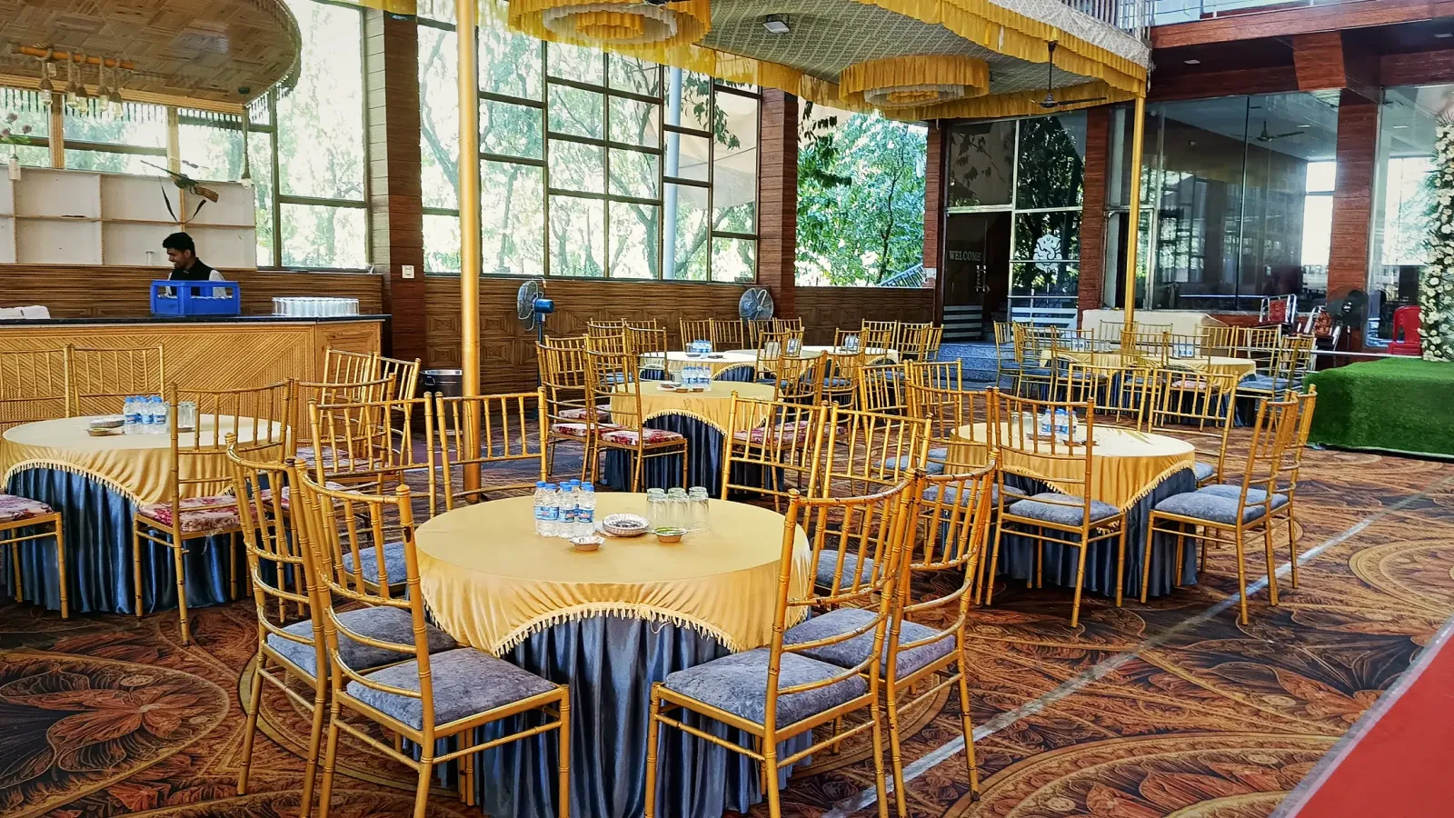 Banquet tables dressed in gold cloth, ready for a reception